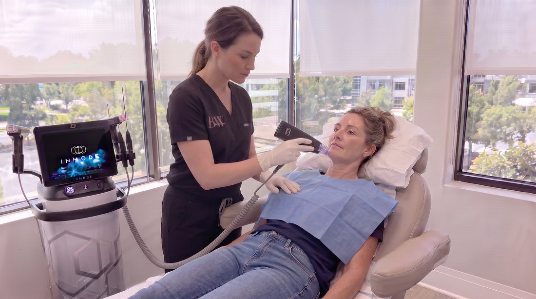 A BodyWorks practitioner treating the jawline with an InMode radiofrequency handpiece in the Alpharetta treatment room