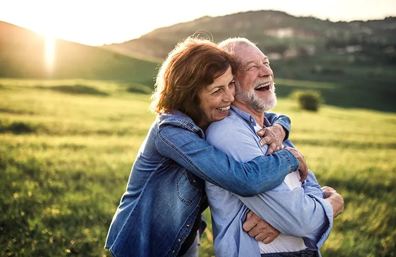 A man and woman Standing outdoors and smiling